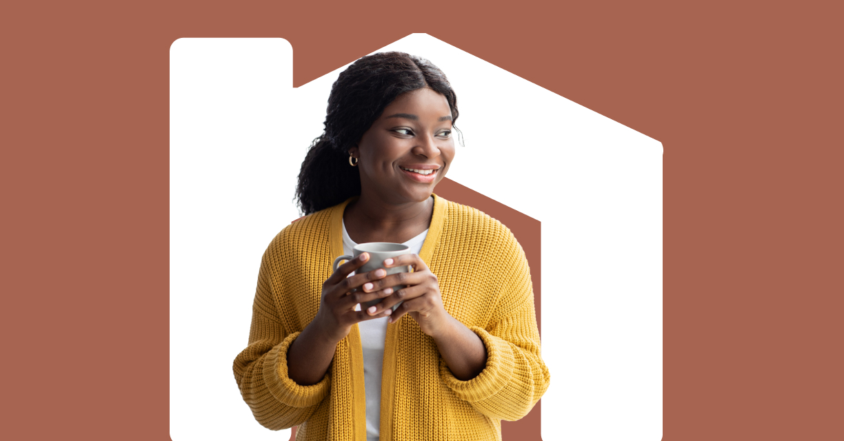 A woman smiling with a mug.